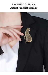 Detail of vintage cat-shaped gold brooch on black blazer with textured metal finish