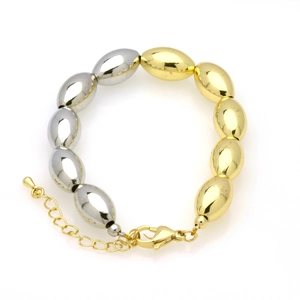Detail of two-tone 18k gold plated copper bead bracelet with lobster clasp and charm