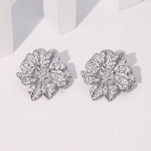 Polished silver floral earrings with irregular hammered texture and multi-petal design
