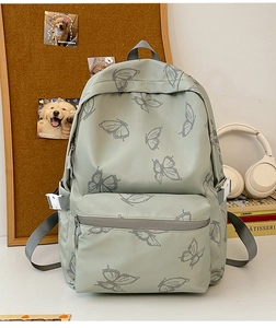 Detail of light green butterfly backpack showing side adjustable buckles and nylon texture