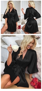 Detail of elegant black satin kimono robe with smooth silk-like texture and matching waist belt