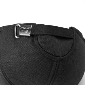 Detail of adjustable silver metal buckle with engraved text on black cotton baseball cap