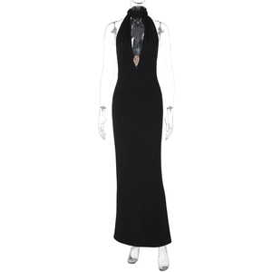 Detail of sexy deep V-neckline on black halter dress featuring a golden lion head ornament