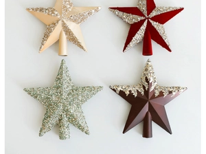 Close-up of sparkling Christmas tree toppers in gold, red, green and bronze glitter finishes