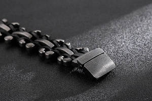 Macro detail of industrial brushed stainless steel men's bracelet with braided structure