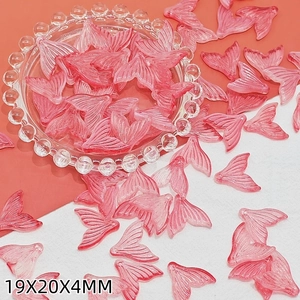 Detailed macro view of 19x20x4mm pink translucent resin fish tail charms for DIY jewelry