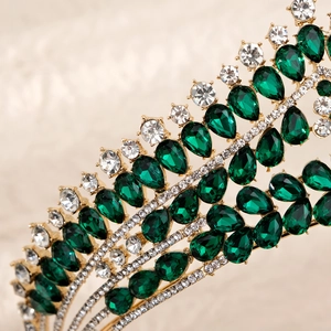 Detail of luxury bridal crown with emerald teardrop crystals and gold metal setting