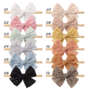 Set of 12 solid color hollow bow baby headbands made of nylon and cotton fabric