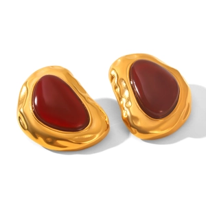Close-up of retro 18k gold plated irregular earrings with deep red resin and hammered texture