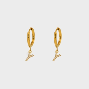 Detailed view of gold plated hoop earrings with Y letter pendant and pavé zircons