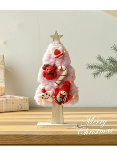 Detailed view of pink wool felt Christmas tree with LED lights and festive ornaments