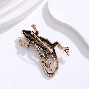 Vintage lizard brooch with sparkling diamonds showing the secure pin back and metal clasp