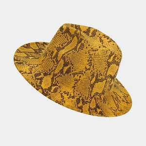 Detail view of the bold yellow snake print pattern on the brim of a wool fedora hat