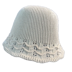 Beige knit bucket hat for women with pointelle wavy pattern and ribbed texture details