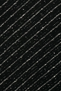 Close-up of black and white tweed knit fabric texture with detailed weaving patterns