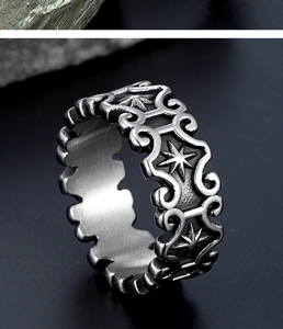 Macro shot of vintage stainless steel band featuring engraved star and vortex patterns