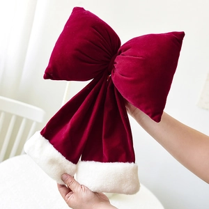 Large red velvet Christmas bow with white faux fur trim for holiday scene decoration