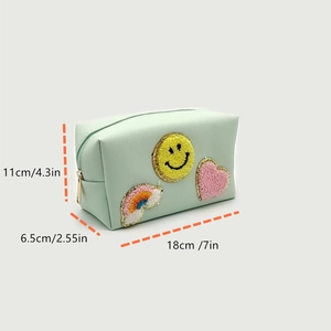 Detail view of mint green toiletry bag with towel-embroidered patches and dimensions
