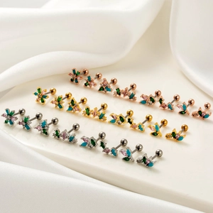 Stainless steel cartilage earring set with colored zircon floral designs on white silk