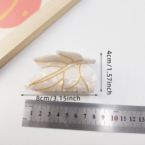 Minimalist white marble leaf hair claw clip with gold veins and 8cm size reference