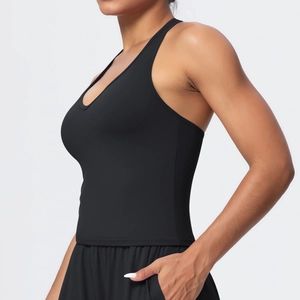Close-up of black matte yoga tank top showing side cut-outs and practical side pockets
