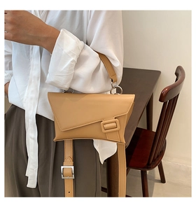 Detail of khaki leather waist bag with asymmetrical flap and silver ring hardware