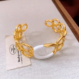 Minimalist gold hollow round link cuff bracelet with white enamel oval centerpiece