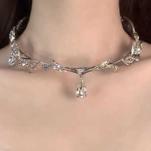 Macro view of silver bridal leaf necklace with a sparkling pear-cut crystal pendant