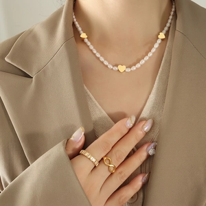 Elegant freshwater pearl necklace with gold heart pendants and matching gold rings