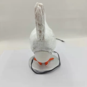 Top view of creative white resin chicken night light with USB power cable and orange claws