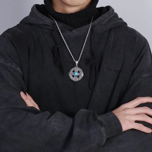 Detail of vintage steel pendant with turquoise inlay and celtic knot on twisted chain