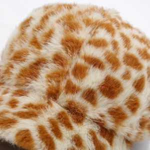 Macro shot of plush faux fur fabric with animal leopard print for winter baseball cap