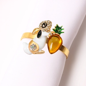Detail of metal bunny napkin ring with white enamel, rhinestones and carrot charm