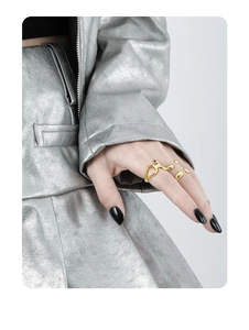 Detail of irregular geometric hollow gold S925 silver ring on model with black nails