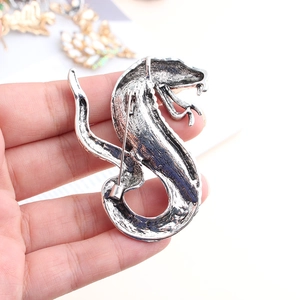 Macro shot of snake-shaped brooch back with metal pin closure in antique silver finish