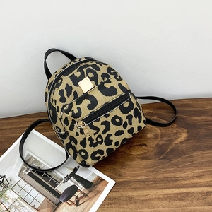 Stylish leopard print mini backpack with black leather straps and gold metal hardware