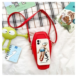 Flat lay of red gothic coffin crossbody bag and creative fish phone case set