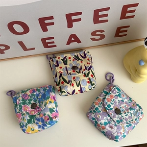 Detailed close-up of three mini floral fabric pouches with secure snap button closure