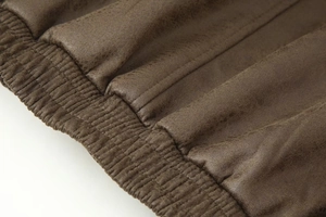 Detail view of dark brown faux suede jacket with premium elastic ribbed cuff finishing