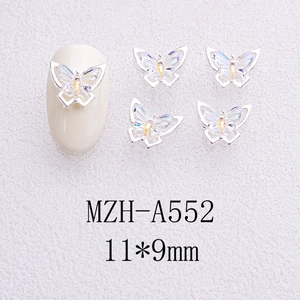 Close-up of 11x9mm iridescent butterfly nail charms with silver alloy base for manicure