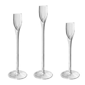 Set of three modern clear glass pillar candle holders in varying heights for table decor