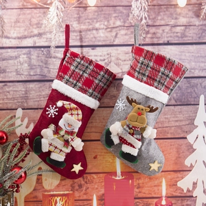 Close-up of felt Christmas stockings with 3D snowman and reindeer embroidery decorations