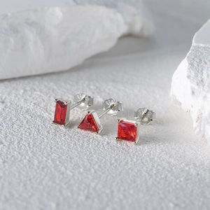 Macro view of geometric red ruby stud earrings with S925 sterling silver hallmarked backings