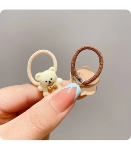 Detail of cute bear and flower hair ties set in beige and brown high elastic knit