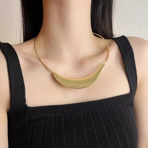 Minimalist gold snake chain choker featuring a sleek curved metal tube pendant for women