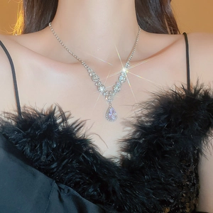 Sparkling silver water drop pendant necklace with zircon crystals on female model