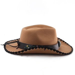 Detail of brown western cowboy hat with floral embroidery on leather band and woven edge