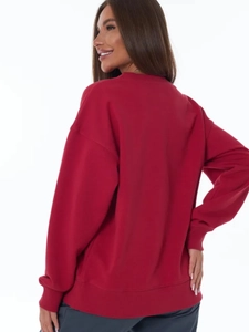Rear view of red oversized sweatshirt featuring dropped shoulders and ribbed hem details