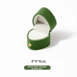 Detailed view of a green heart velvet jewelry box with gold ball clasp measuring 4x4x4cm
