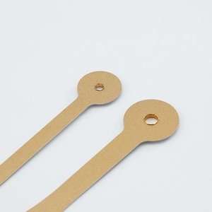 Golden clock hands with fine matte texture and circular mounting hole on white background